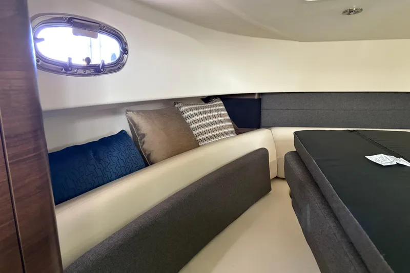Amy Yacht Photos Pics 2018 Boston Whaler 345 Conquest cabin interior with cushions and porthole window.