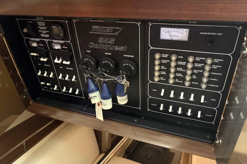 Amy Yacht Photos Pics Control panel of a 2018 Boston Whaler 345 Conquest boat, featuring various switches and gauges.