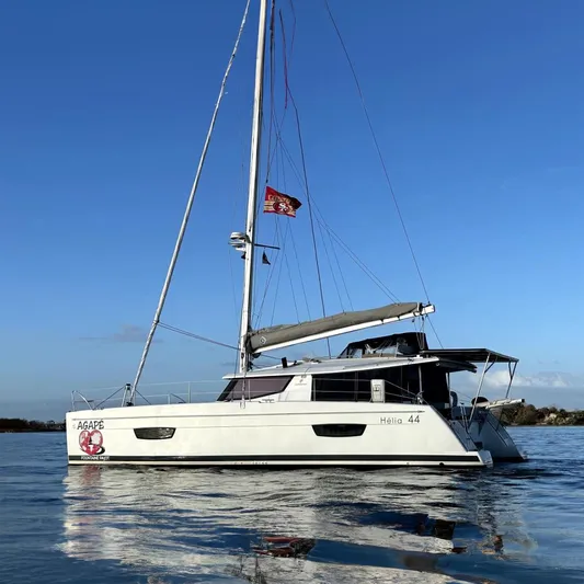  Yacht Photos Pics 2019 Fountaine Pajot Helia 44 Evolution catamaran sailing on calm waters under clear blue sky.