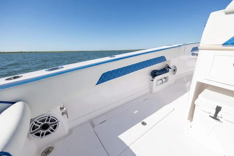  Yacht Photos Pics 2022 Blackwater 36 Sport boat interior with blue accents, ocean view, and clear sky.