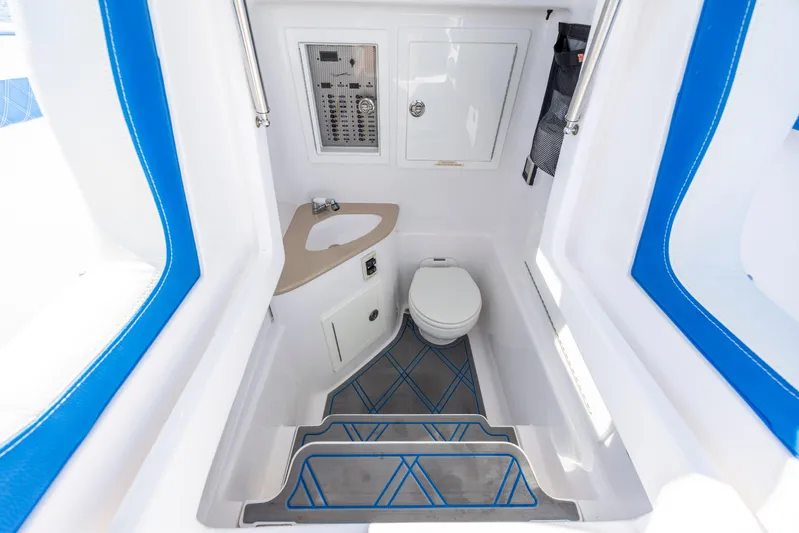  Yacht Photos Pics 2022 Blackwater 36 Sport boat interior with modern bathroom and control panel.