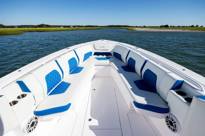  Yacht Photos Pics 2022 Blackwater 36 Sport boat with spacious seating, blue accents, and scenic water view.