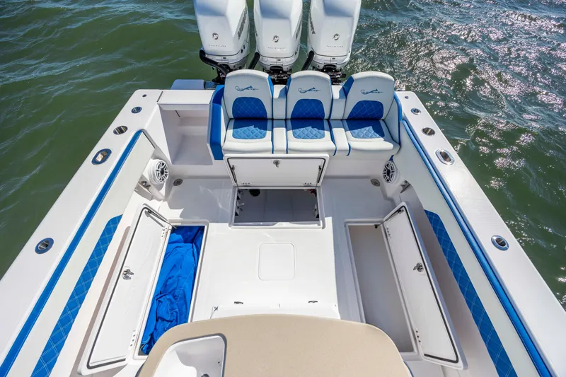  Yacht Photos Pics 2022 Blackwater 36 Sport boat deck with blue seating and storage compartments.