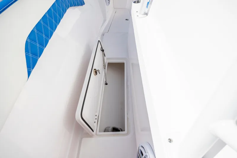  Yacht Photos Pics 2022 Blackwater 36 Sport boat storage compartment with open hatch and blue seating.