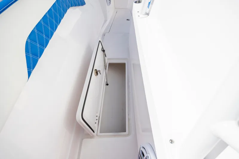  Yacht Photos Pics 2022 Blackwater 36 Sport boat storage compartment with open hatch and blue seating.