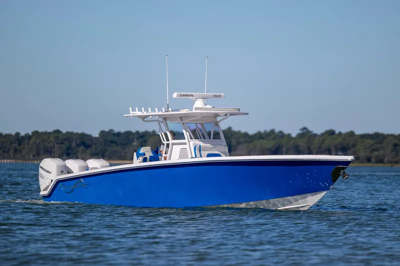  Yacht Photos Pics 2022 Blackwater 36 Sport boat cruising on calm water, featuring a sleek blue hull.