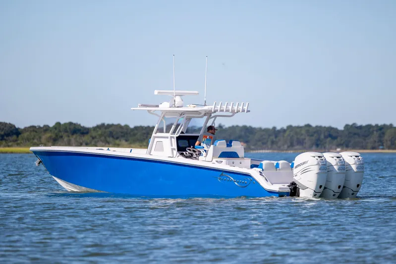  Yacht Photos Pics 2022 Blackwater 36 Sport boat with triple Mercury engines on calm water.