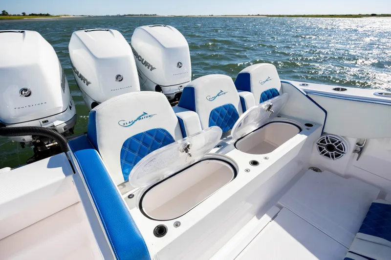  Yacht Photos Pics 2022 Blackwater 36 Sport boat with Mercury engines and blue seating on open water.
