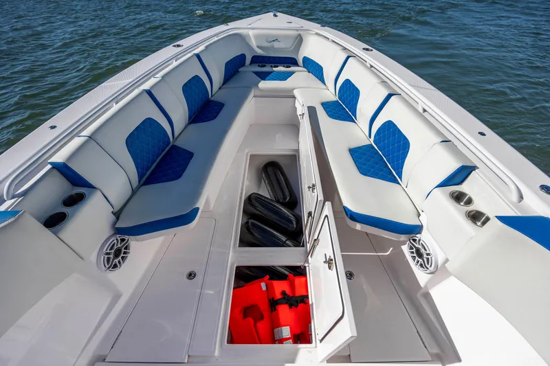  Yacht Photos Pics 2022 Blackwater 36 Sport boat interior with blue and white seating and storage compartments.