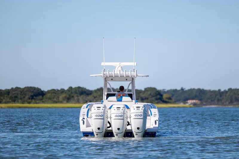  Yacht Photos Pics 2022 Blackwater 36 Sport boat with triple 400 engines on a calm lake.
