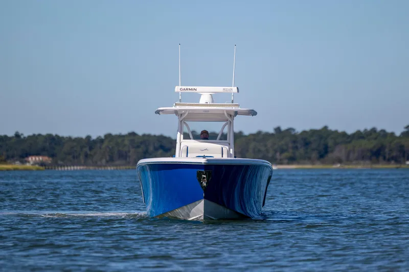  Yacht Photos Pics 2022 Blackwater 36 Sport boat cruising on a calm lake with forested shoreline.