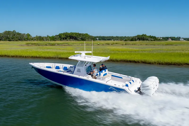  Yacht Photos Pics 2022 Blackwater 36 Sport boat cruising on a scenic waterway with lush greenery.