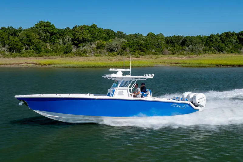  Yacht Photos Pics 2022 Blackwater 36 Sport boat cruising on a scenic waterway with lush greenery.