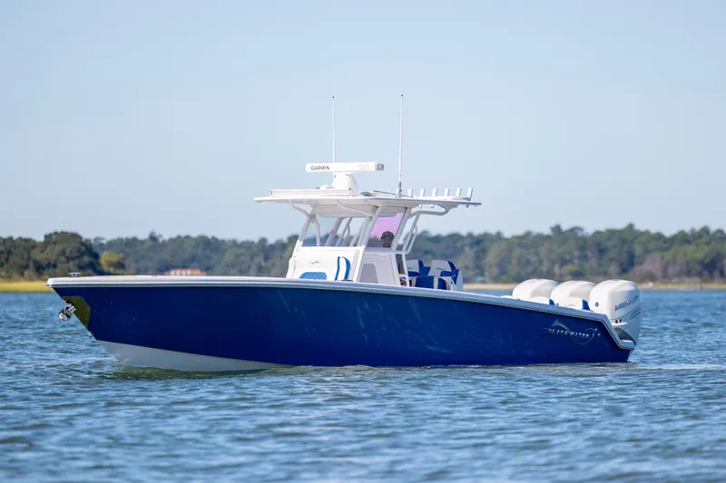  Yacht Photos Pics 2022 Blackwater 36 Sport boat on water, featuring sleek blue design and powerful engines.