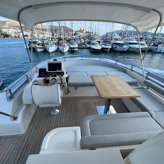  Yacht Photos Pics Luxurious 2007 Apreamare 65 yacht interior with helm, seating, and table, docked at marina.