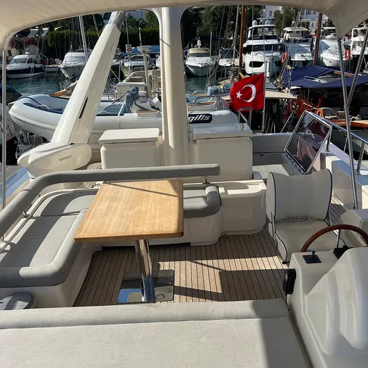  Yacht Photos Pics Luxurious 2007 Apreamare 65 yacht deck with seating, table, and Turkish flag in marina.