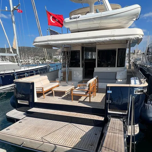  Yacht Photos Pics Luxury 2007 Apreamare 65 yacht with Turkish flag, docked at marina, featuring spacious deck seating.