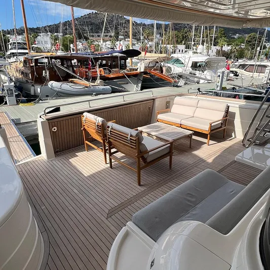  Yacht Photos Pics Luxury yacht deck with wooden furniture, Apreamare 65, 2007 model, docked at marina.