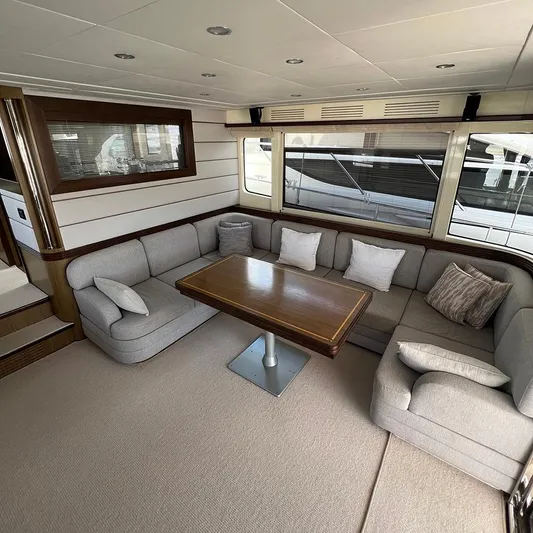  Yacht Photos Pics Luxurious interior of 2007 Apreamare 65 yacht with plush seating and wooden table.