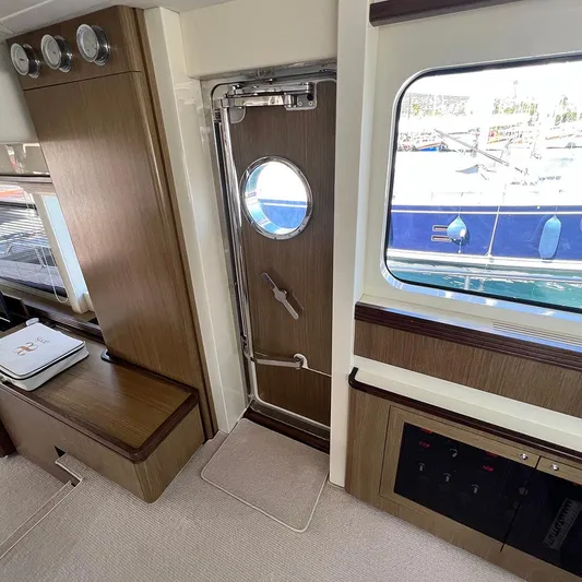  Yacht Photos Pics Interior of 2007 Apreamare 65 yacht with wooden door and porthole window.