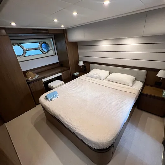 Yacht Photos Pics Luxurious bedroom interior of 2007 Apreamare 65 yacht with elegant wood finishes and cozy bedding.
