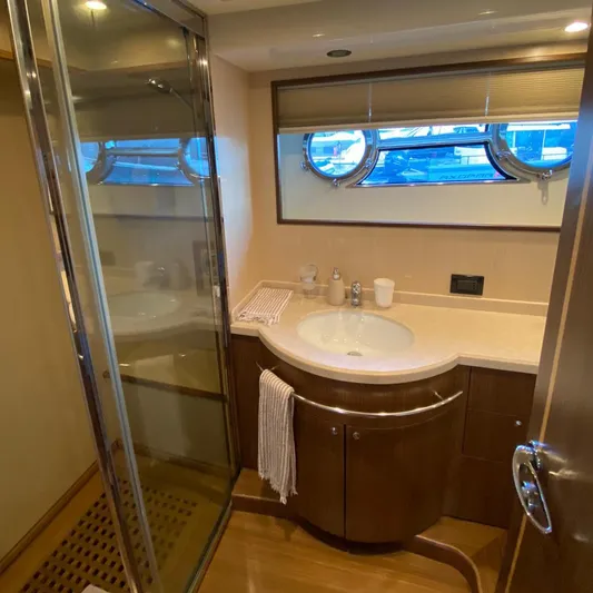  Yacht Photos Pics Luxurious bathroom in 2007 Apreamare 65 yacht with modern fixtures and porthole window.