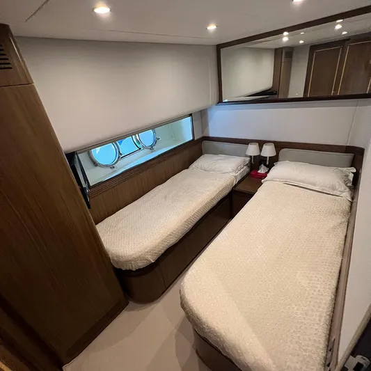  Yacht Photos Pics Twin bedroom in a 2007 Apreamare 65 yacht, featuring cozy beds and porthole windows.