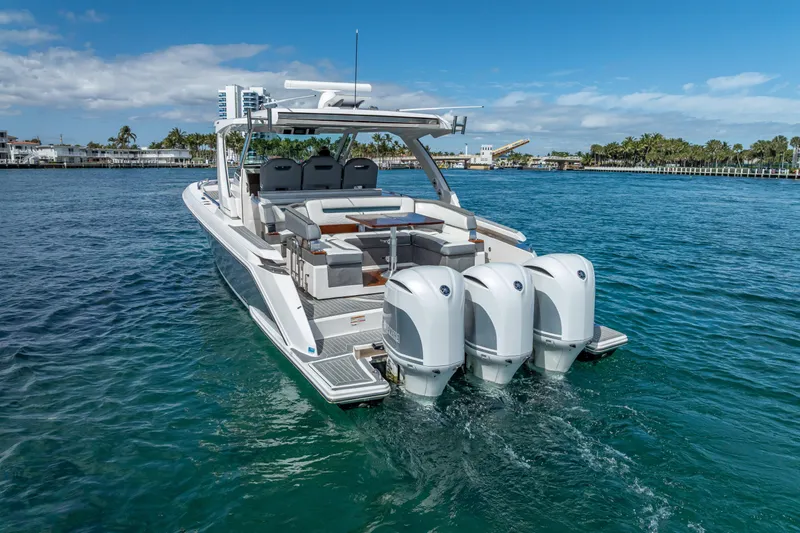  Yacht Photos Pics 2019 Tiara Sport 38 LS boat cruising on clear blue water.