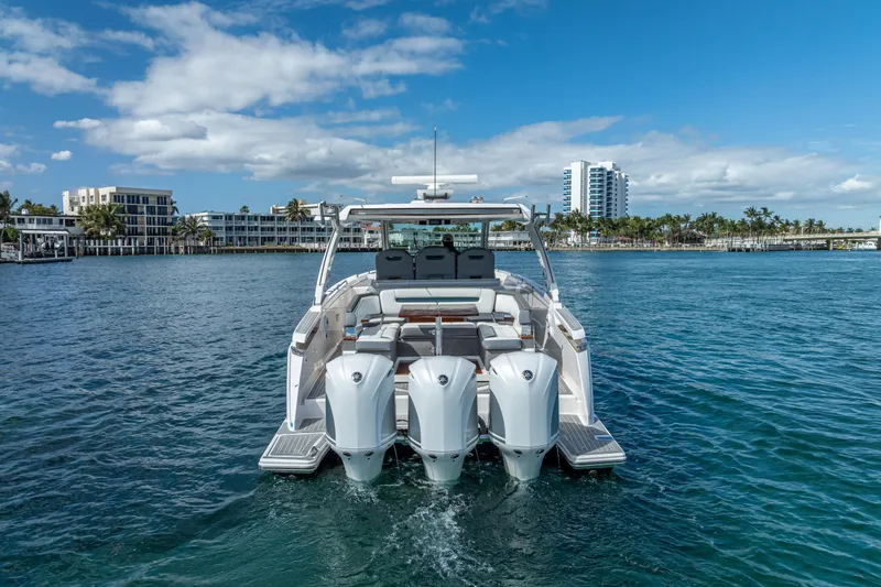  Yacht Photos Pics 2019 Tiara Sport 38 LS boat on water, cityscape background, clear sky.