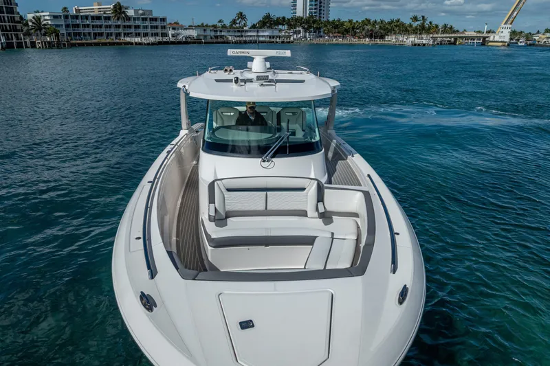  Yacht Photos Pics 2019 Tiara Sport 38 LS luxury boat cruising on clear blue water.