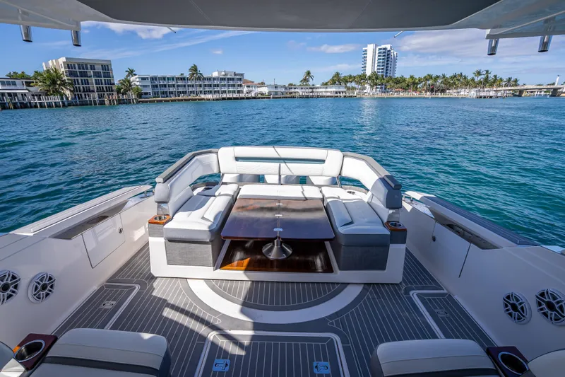  Yacht Photos Pics 2019 Tiara Sport 38 LS yacht with luxurious seating, docked near waterfront buildings.