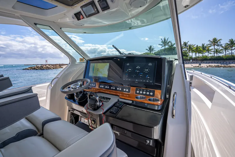  Yacht Photos Pics 2019 Tiara Sport 38 LS boat cockpit with advanced navigation system, steering wheel, and ocean view.