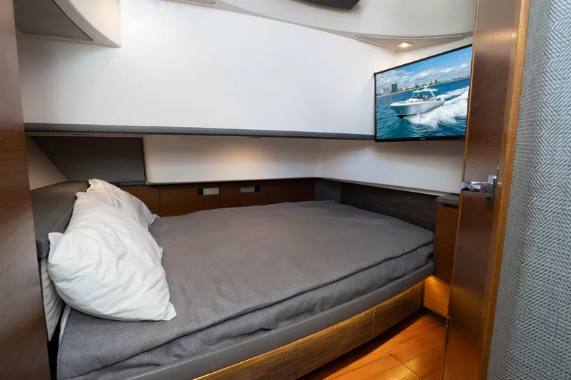  Yacht Photos Pics Interior cabin of 2019 Tiara Sport 38 LS with bed and wall-mounted TV.