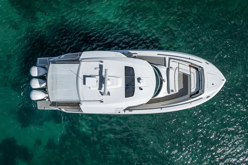  Yacht Photos Pics Aerial view of 2019 Tiara Sport 38 LS boat on clear turquoise water.