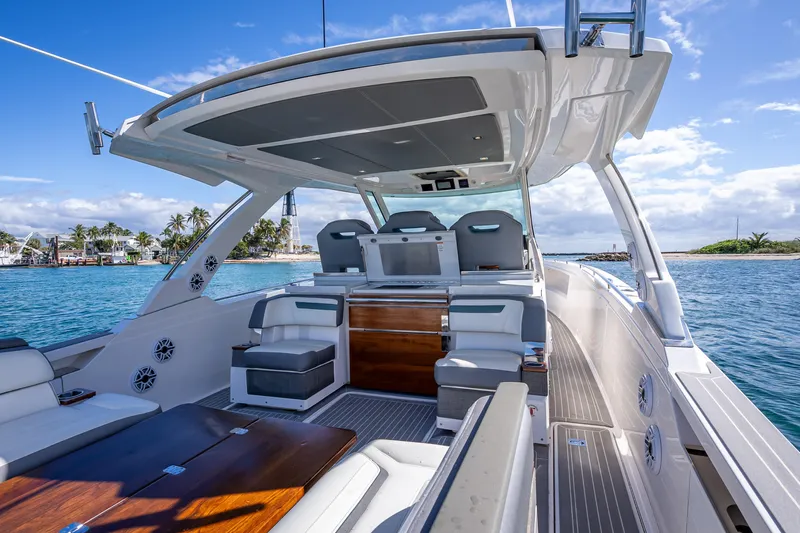  Yacht Photos Pics Luxurious 2019 Tiara Sport 38 LS yacht interior with seating, cruising on clear blue waters.