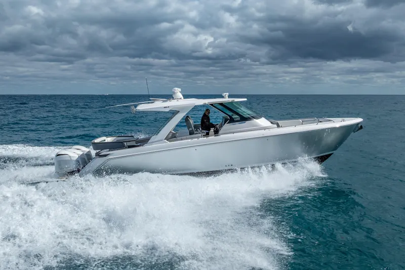  Yacht Photos Pics 2019 Tiara Sport 38 LS cruising on open ocean under cloudy skies.