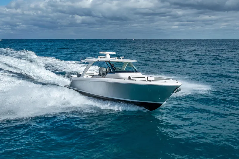  Yacht Photos Pics 2019 Tiara Sport 38 LS cruising on open ocean under cloudy sky.