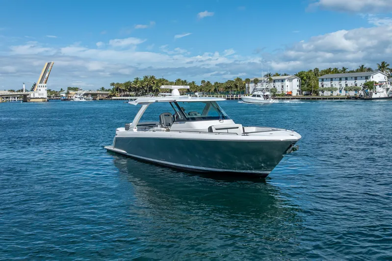  Yacht Photos Pics 2019 Tiara Sport 38 LS boat cruising on a sunny day near a drawbridge.