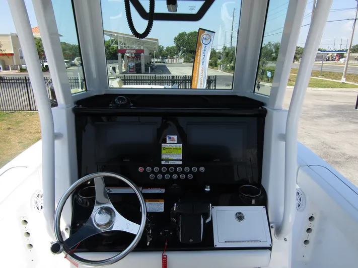  Yacht Photos Pics 2024 Wellcraft 243 Fisherman boat dashboard with steering wheel and control panel.