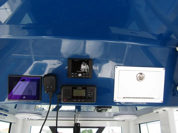  Yacht Photos Pics 2024 Wellcraft 243 Fisherman boat dashboard with navigation and communication equipment.