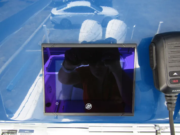  Yacht Photos Pics 2024 Wellcraft 243 Fisherman boat dashboard with Garmin display and radio.