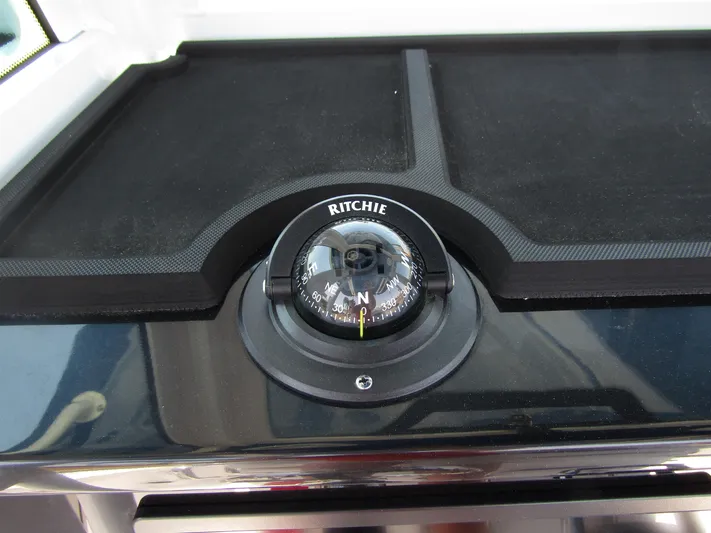  Yacht Photos Pics 2024 Wellcraft 243 Fisherman compass on dashboard.