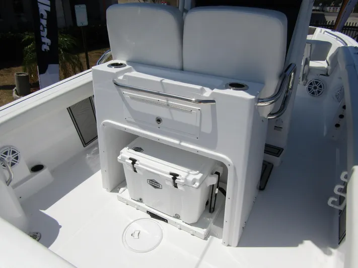  Yacht Photos Pics 2024 Wellcraft 243 Fisherman boat interior with cooler storage and seating.
