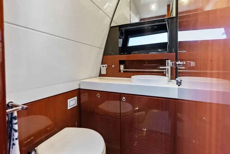 La Ruta Yacht Photos Pics Luxurious bathroom interior of 2017 Riva Rivamare yacht with modern fixtures and wooden cabinetry.