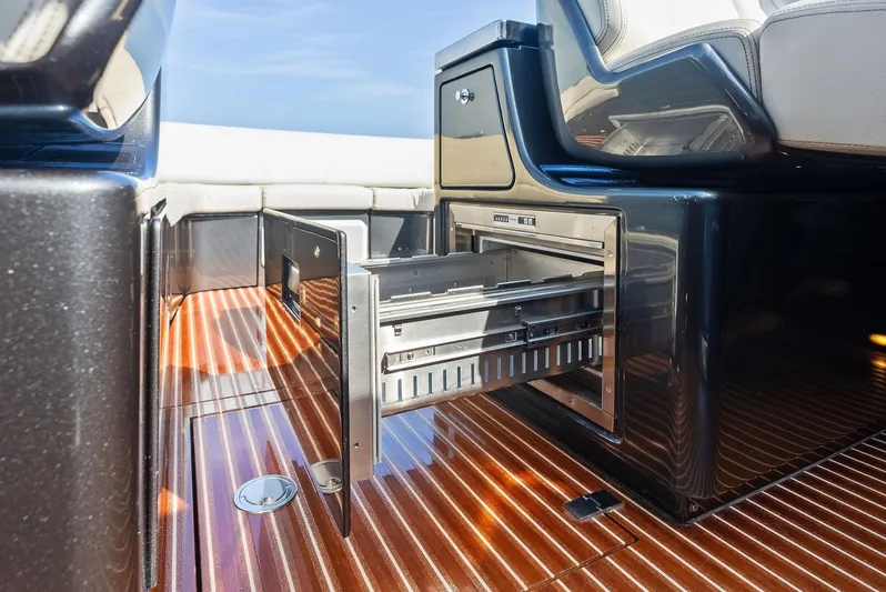 La Ruta Yacht Photos Pics Open storage drawer on 2017 Riva Rivamare yacht with sleek wooden flooring.
