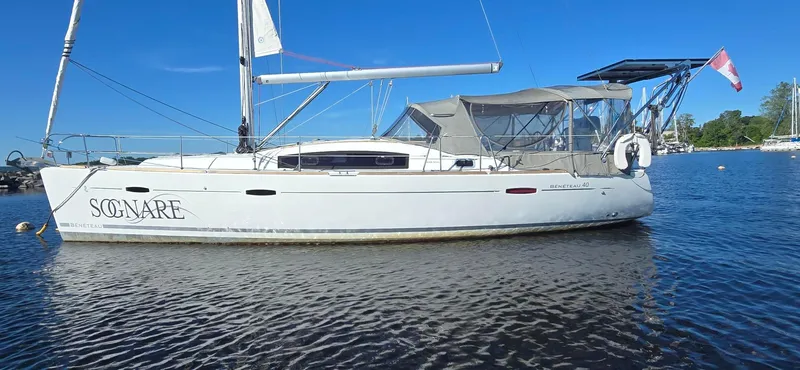 Sognare Yacht Photos Pics 2011 Beneteau Oceanis 40 sailboat on calm water, clear blue sky background.