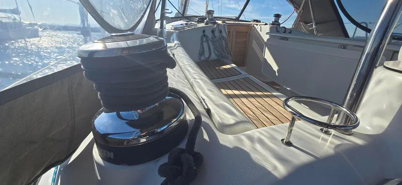 Sognare Yacht Photos Pics Beneteau Oceanis 40 sailboat deck, 2011 model, featuring winch and teak flooring under sunny skies.
