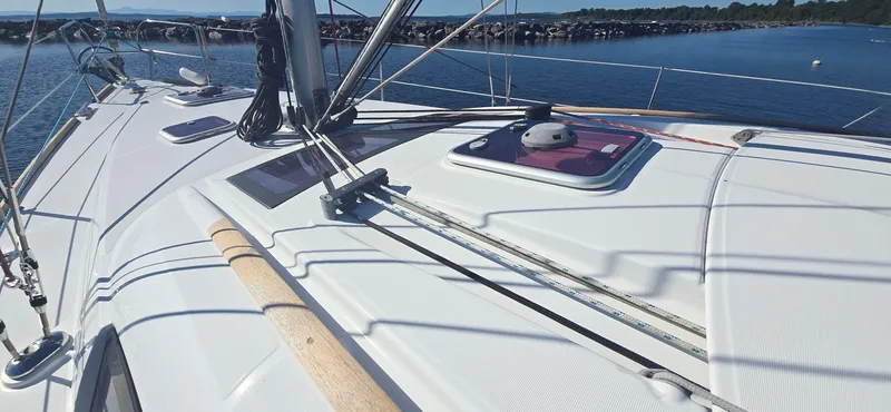 Sognare Yacht Photos Pics Beneteau Oceanis 40 sailboat deck, 2011 model, on calm water with clear skies.