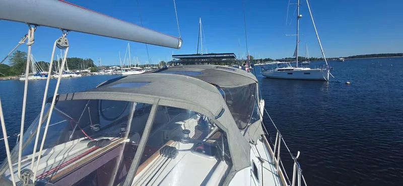 Sognare Yacht Photos Pics Beneteau Oceanis 40 sailboat, 2011 model, docked in a serene marina under clear blue skies.
