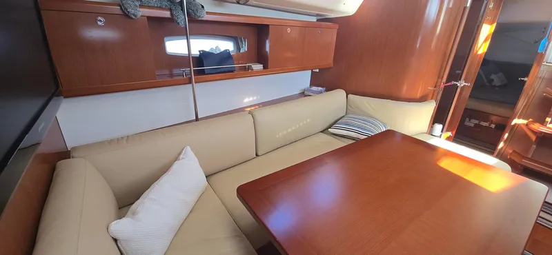 Sognare Yacht Photos Pics Interior of 2011 Beneteau Oceanis 40 sailboat with cozy seating and wooden table.